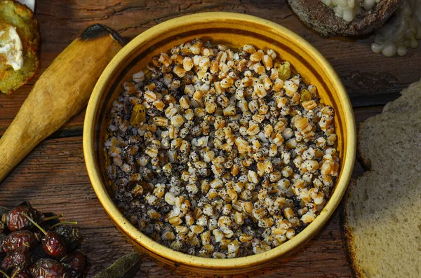 Crumbly pearl barley porridge.  Fresh homemade pearled barley. Pearl barley in bowl on a wooden table