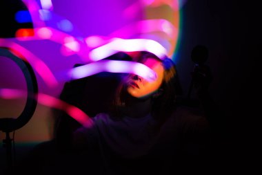 Blogger content creator using mobile phone gadget. Woman blogger influencer creating vlog video for social media.