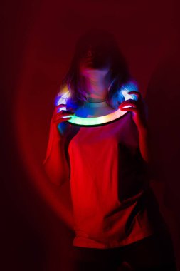 Dynamic portrait of woman dancing in mixed neon stage light. Concept of action and creativity.