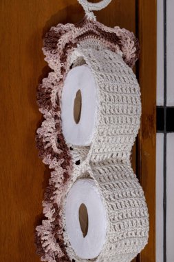 Brown crochet toilet paper roll holder in detail clipart