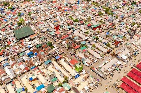 Streets of poor areas in Manila. The roofs of houses and the life of people in the big city. Poor districts of Manila, view from above.