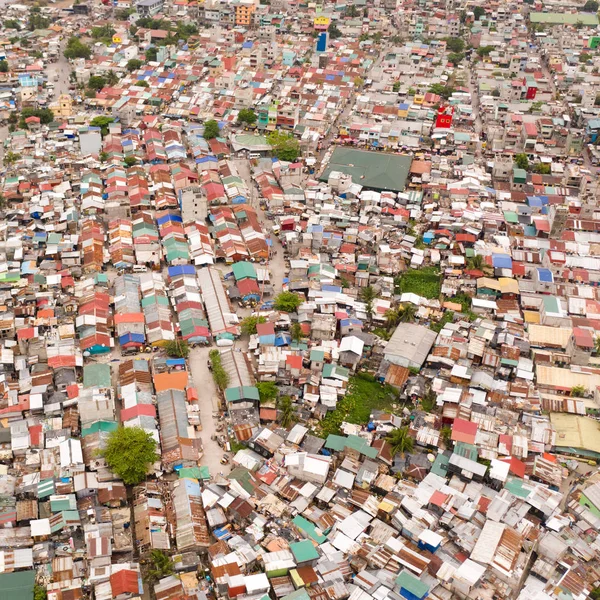 Streets of poor areas in Manila. The roofs of houses and the life of people in the big city. Poor districts of Manila, view from above.