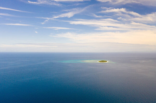 Seascape with a small island in the distance.Tropical island Mantigue, Philippines.