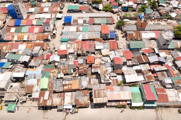 Streets of poor areas in Manila. The roofs of houses and the life of people in the big city. Poor districts of Manila, view from above.