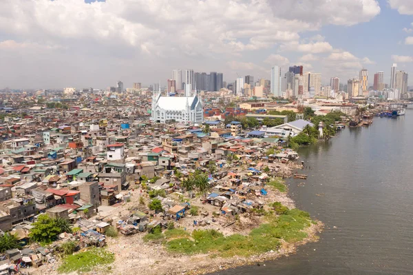 The urban landscape of Manila, with slums and skyscrapers. Sea port and residential areas. The contrast of poor and rich areas. Contrast social strata.