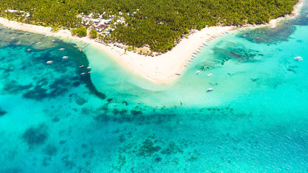 Coastline of a tropical island with a white beach and turquoise lagoon. Daco island, Philippines.