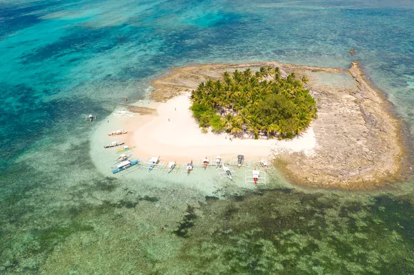 Guyam island, Siargao, Philippines. Small island with palm trees and a white sandy beach.
