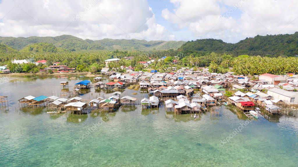 Dapa, Siargao, Philippines. Fishing village with wooden houses, standing on stilts in the sea, top view.