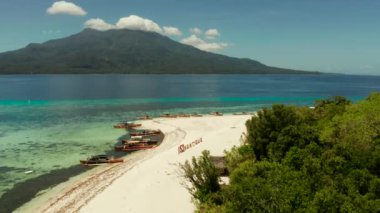 Mantigue adasında beyaz kumlu plaj, Filipinler. Beyaz kumlu plaj ve tekneler.