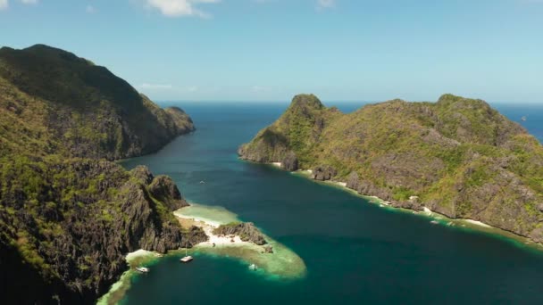白いビーチのある岩の海岸。ジャングルのある熱帯の島。熱帯海水ラグーンとビーチ、フィリピン、エルニド. — ストック動画