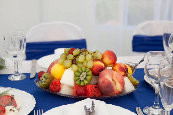 Plate with fruits on the table.