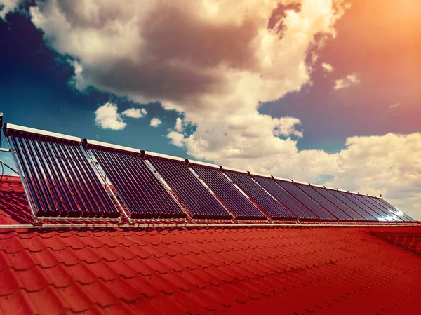 Residential red roof tile with with solar panel