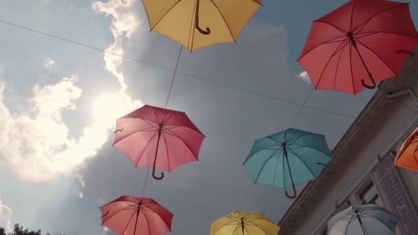 Multicolored umbrellas soar in the sky — Stock Video