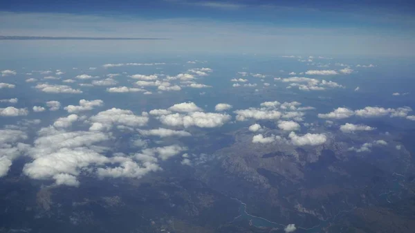 Visa genom ett flygplan fönster. Moln, sol, sky sedd genom fönstret på ett flygplan — Stockfoto