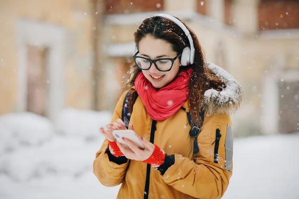 Portrait close-up young woman in the winter city, smiling