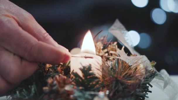 Close-up of a mans hand lighting a candle — Stock Video