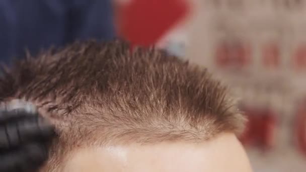 Close-up de mãos masculinas de cabeleireiro. Penteado masculino em uma barbearia ou salão de cabeleireiro. Barbearia . — Vídeo de Stock