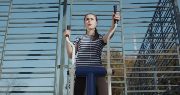 Frau beim Fitnesstraining in der Outdoor-Turnhalle im Park. Sport- und Fitnesstraining im Freien. Aktives Lebens- und Trainingskonzept. — Stockvideo