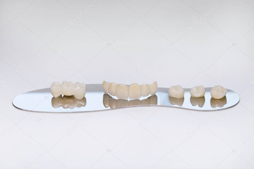 Zirconium tooth crown. Isolate on background. Aesthetic restoration of tooth loss. Ceramic zirconium in final version. Metal Free Ceramic Dental Crowns