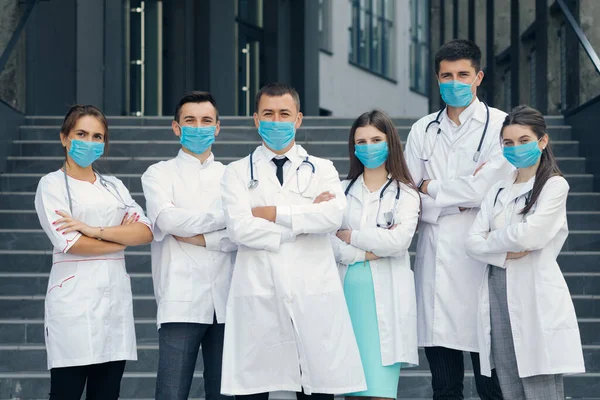 Group of Doctors With Face Masks Looking at Camera. Teamwork Specialist Doctors . Corona Virus and Healthcare Concept