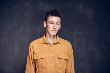 Siyah arka planda göz kırpan beyaz bir adam.