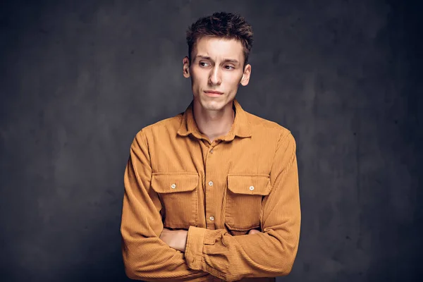 Thoughtful young caucasian man on dark background — Stock Photo, Image