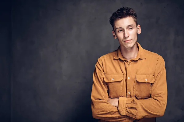 Thoughtful young caucasian man on dark background — Stock Photo, Image