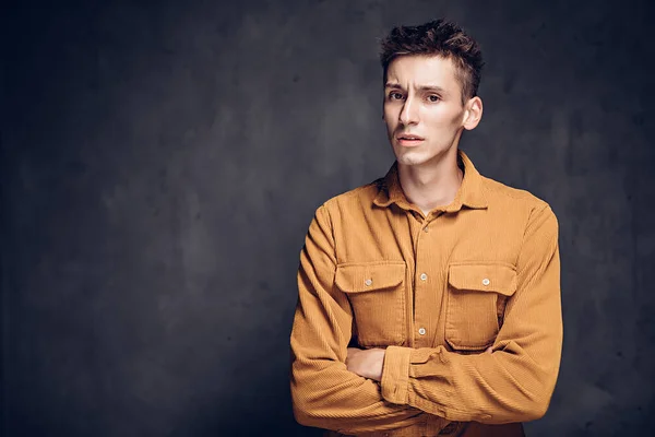 Displeased young caucasian man on dark background — Stock Photo, Image