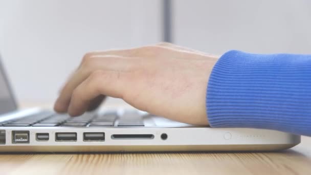Primer plano - manos masculinas están escribiendo mensaje en un ordenador portátil — Vídeo de stock