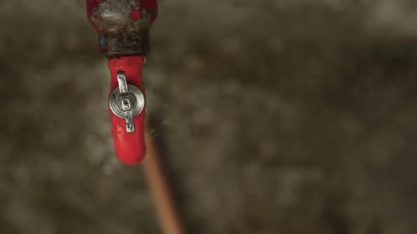 Wasting Water Dripping Old Red Outdoor Faucet — Stock Video