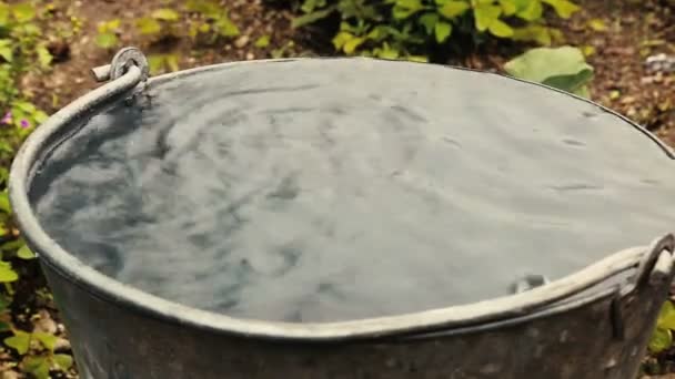 Rain water drop inside steel bucket — стоковое видео