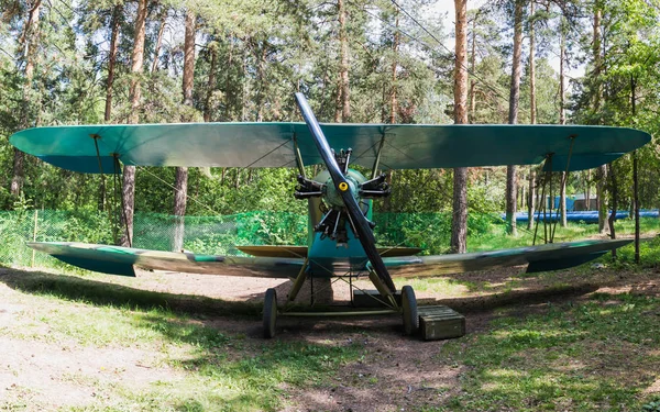 Old vintage biplane on a forest airfield