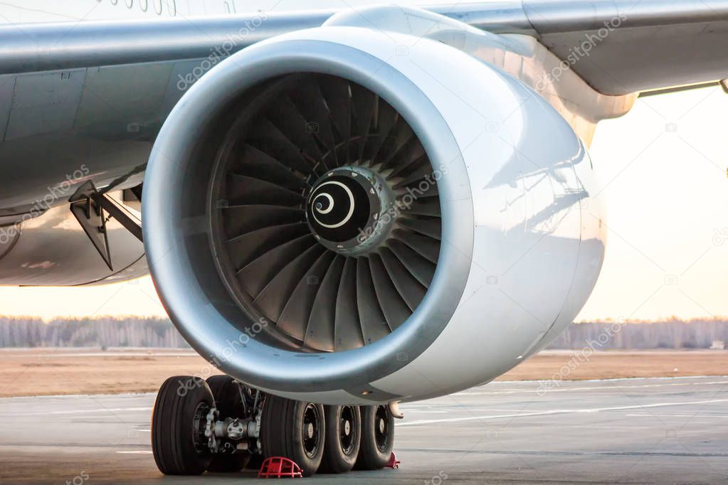 Close-up of engine of big white passenger airplane