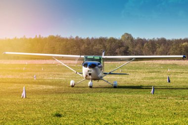 Akşam güneşin ışınları havaalanında küçük bir özel uçak taxiing