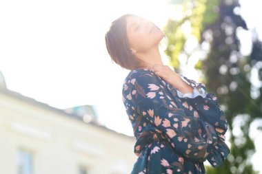 Şirin ve uzun mavi elbise güzel genç bir bayanla günbatımı keyfini çıkarın. Güzel yaz akşamında. Sunlights. Moda ve stil kavramı.