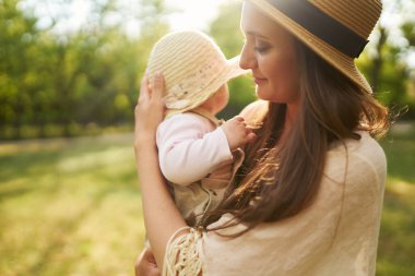 mutlu uyumlu aile açık havada. Anne ile bebeği var fan, gülüyor ve niteliğine yaz oynarken. mutlu bir aile kavramı. yaz gecesi