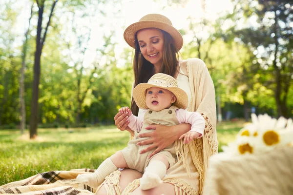 mutlu uyumlu aile açık havada. Anne ile bebeği var fan, gülüyor ve niteliğine yaz oynarken. mutlu bir aile kavramı. yaz gecesi
