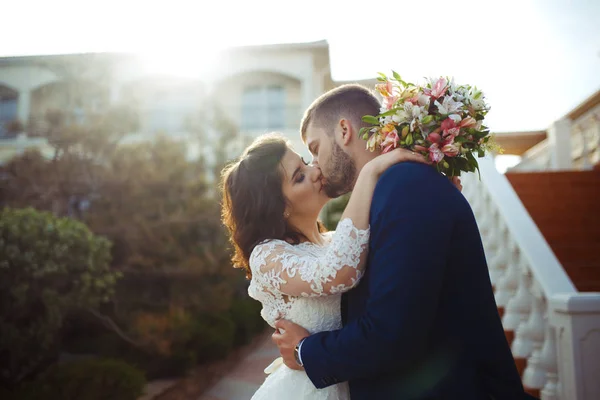 Beautiful Bride and Groom enjoy each other. happy romantic young couple celebrating their marriage. Sexy kissing stylish couple of lovers close up portrait. wedding concept.