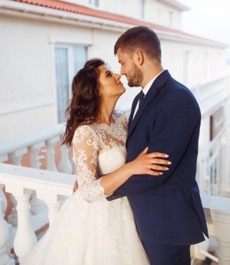 Güzel gelin ve damat hoşlanıyoruz. onların evlilik kutlama mutlu romantik genç bir çift. Aşıkların seksi öpüşme şık çift portre kadar kapatın. Düğün kavramı. günbatımı ışığı