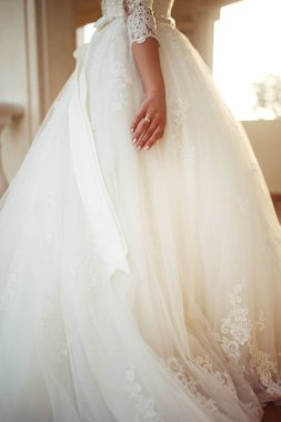 Beyaz bir gelinlikle çok güzel bir gelin şu sedyeyi günbatımı ışığı güzel bir kemer karşı keyif alıyor. İyi bir ruh hali, harika bir atmosfer. Düğün kavramı.