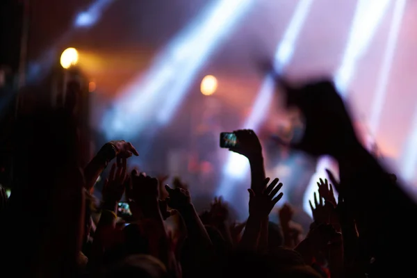 Use advanced mobile recording, fun concerts and beautiful lighting, Candid image of crowd at rock concert, Close up of recording video with smartphone, Enjoy the use of mobile photography