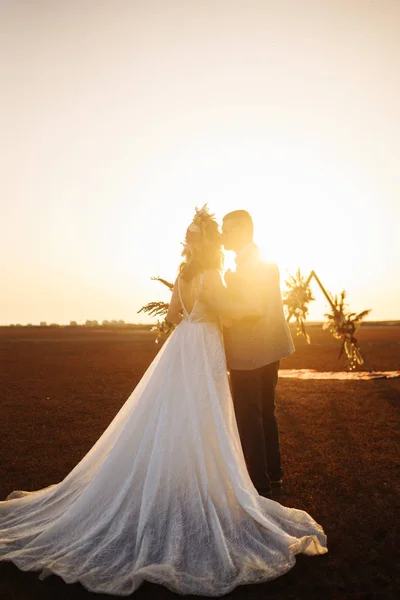 年轻美丽的新郎新娘享受对方 在博霍风格的婚礼日 阳光描绘的幸福的新娘和新郎在自然在日落时的户外 温暖的夏日时光 — 图库照片