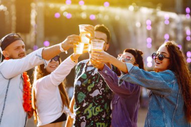 Bira dansı yapan ve müzik festivalinde eğlenen bir grup arkadaş. Yaz plajı partisi, tatil, tatil konsepti. Gençlik ve kutlama konsepti..