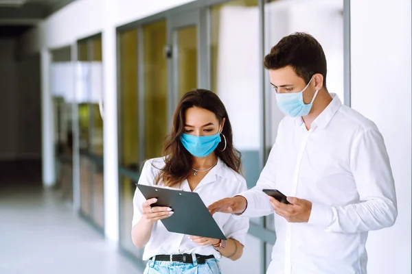 Business people with face mask working in the office. The concept of preventing the spread of the epidemic and treating coronavirus, pandemic in quarantine city. Covid-19.