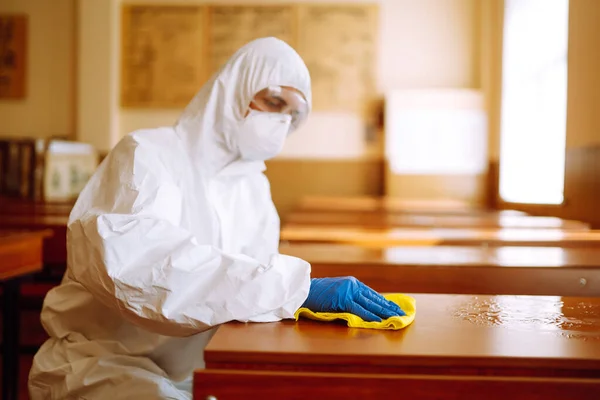 Cleaning and disinfection school desk during coronavirus pandemic. COVID-19.