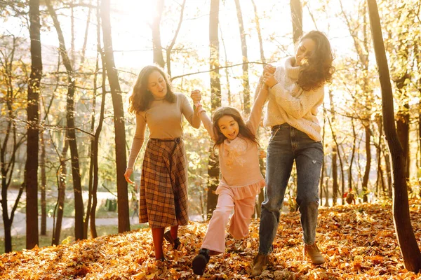 Güzel bir çift lezbiyen kız evlatlık kızlarıyla sonbahar ormanında eğleniyor. Genç homoseksüel aile kızıyla oynuyor.. 