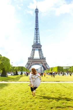 Romantik Paris 'te Fransız tatili sırasında, arka planda Eyfel Kulesi olan gülümseyen kadın kaygısız hissediyordu. Yolculukta manzaranın tadını çıkaran genç bir kadın. Tatil, turizm, seyahat, yaşam tarzı konsepti.
