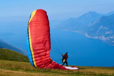 parachutist man getting ready to fly, action sport in mountains 