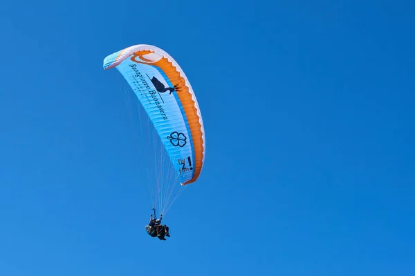 blue sky and parachutist skydiving in sky 
