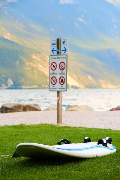 beautiful nature, lake water and surf board and wooden beach sign 